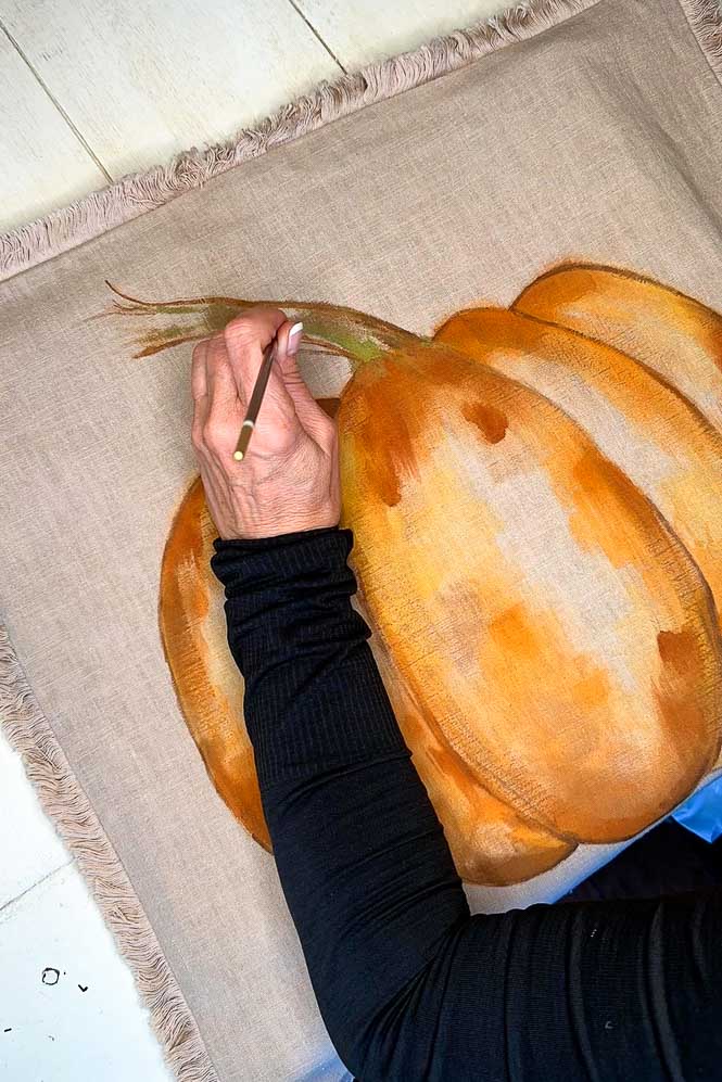 Painting the stem of the pumpkin