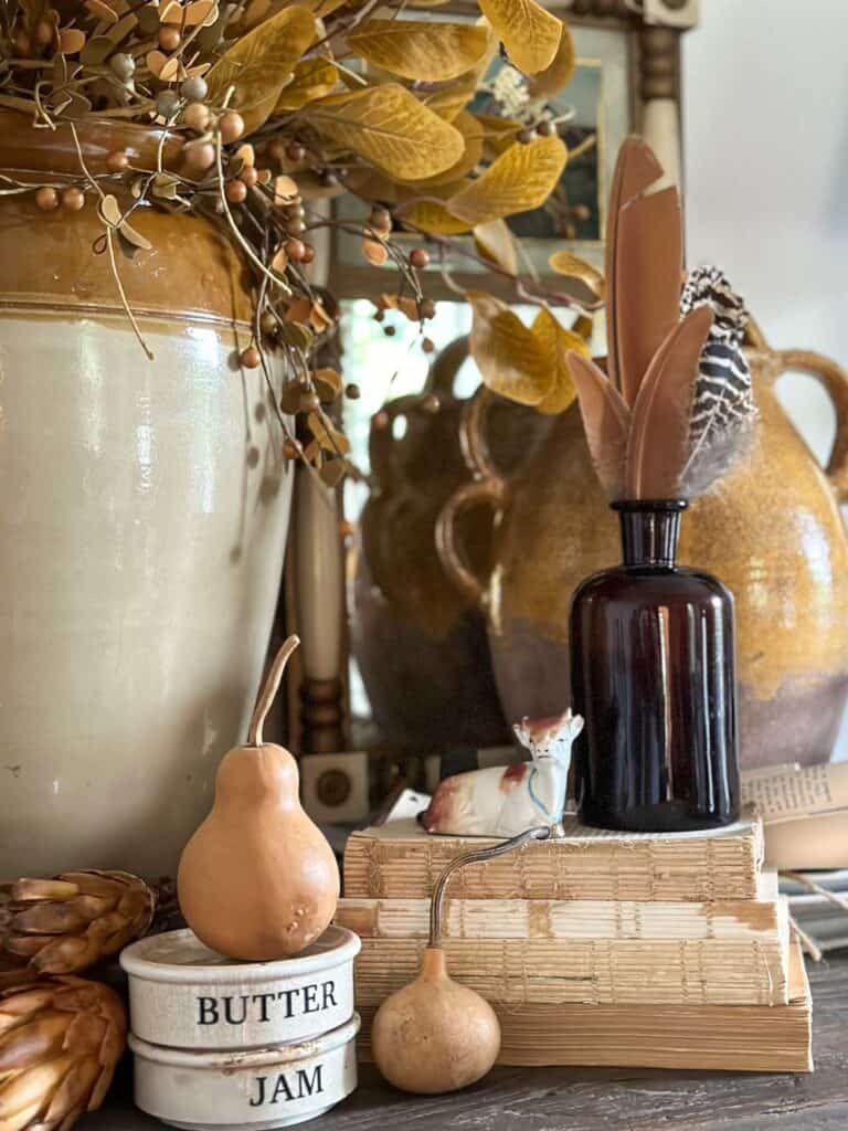 Adding texture to your fall vignette with books, wicker, feathers, glass etc. 