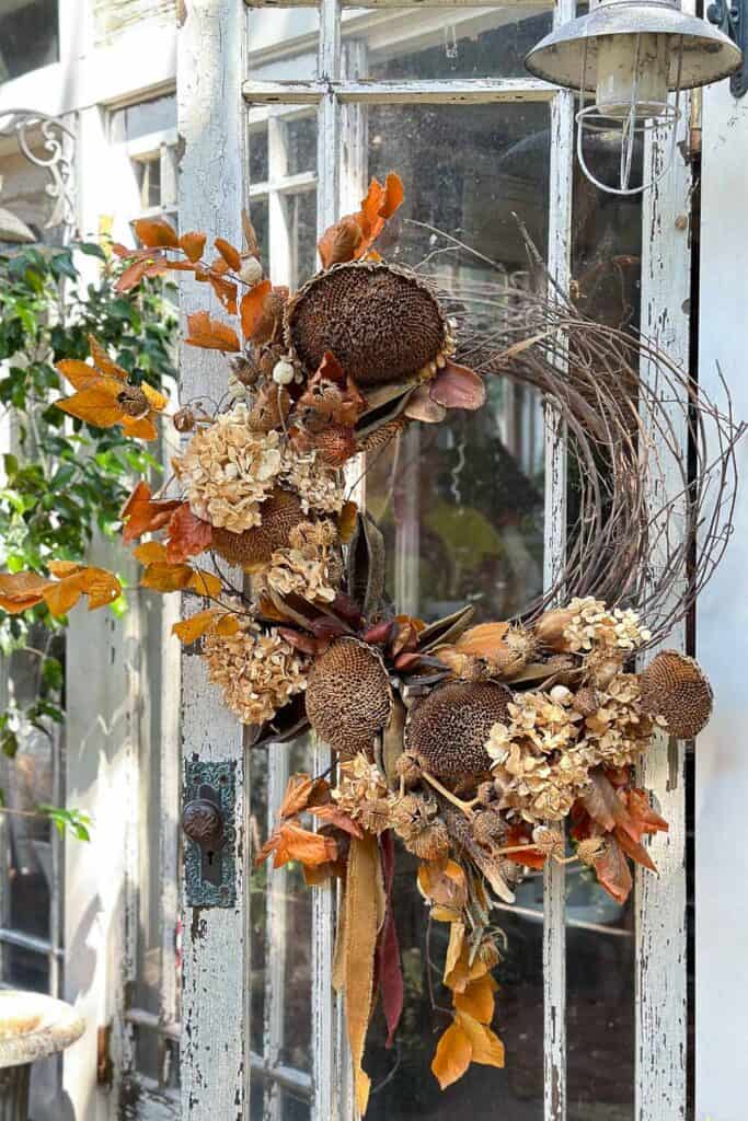 The finished foraged wreath was filled with dried leaves, sunflowers, pods of velvet ribbon, and hydrangeas.