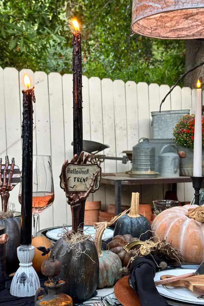 Dripping black candle son a Halloween tablescape 