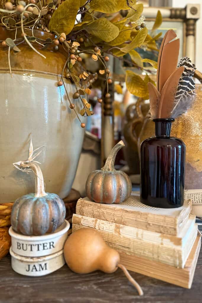 Vintage books paired with small pumpkins for a fall vignette.