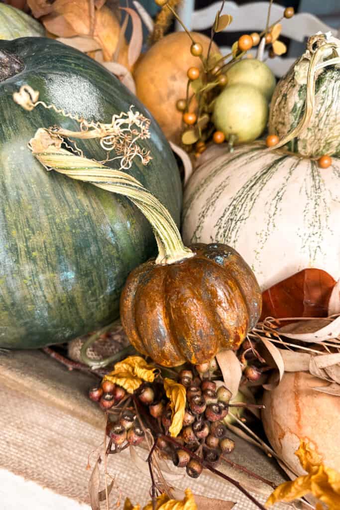 Pumpkins in a wooden dough bowl for a centerpiece on the kitchen table. 