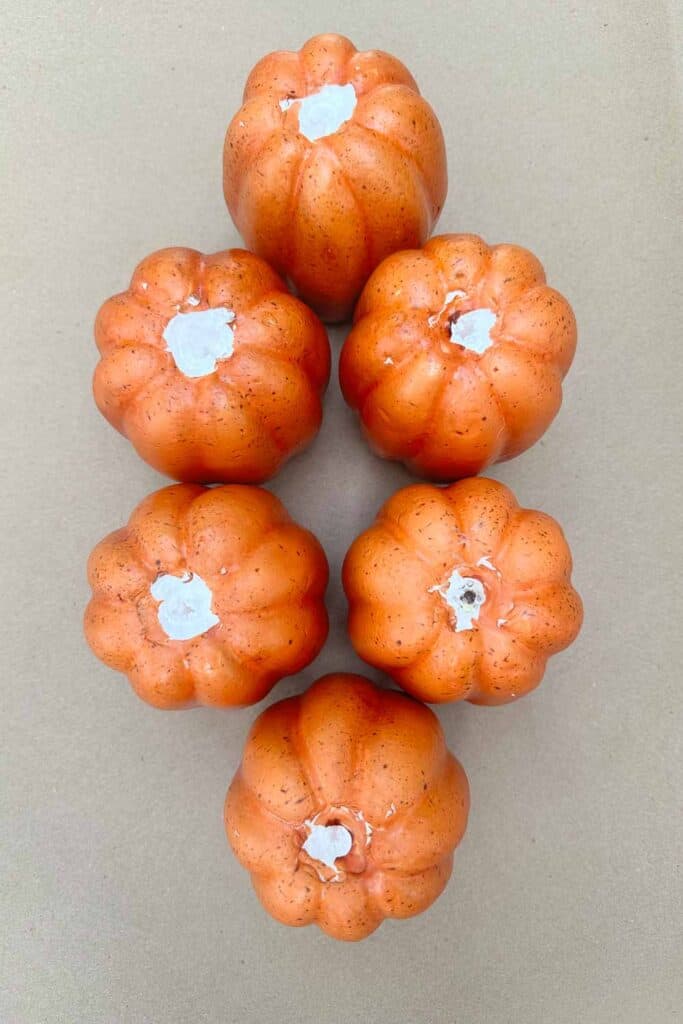 Orange foam pumpkins that have had their stems removed. 