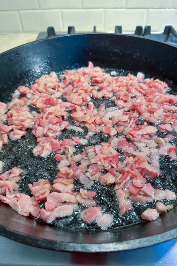 Bacon frying in a cast iron pan