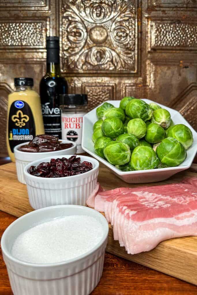 Ingredients for making smoked Brussels sprouts with Maple Bacon and dates - Brussels sprouts, bacon, sugar, mustard, Wright rub and Balsamic dressing.