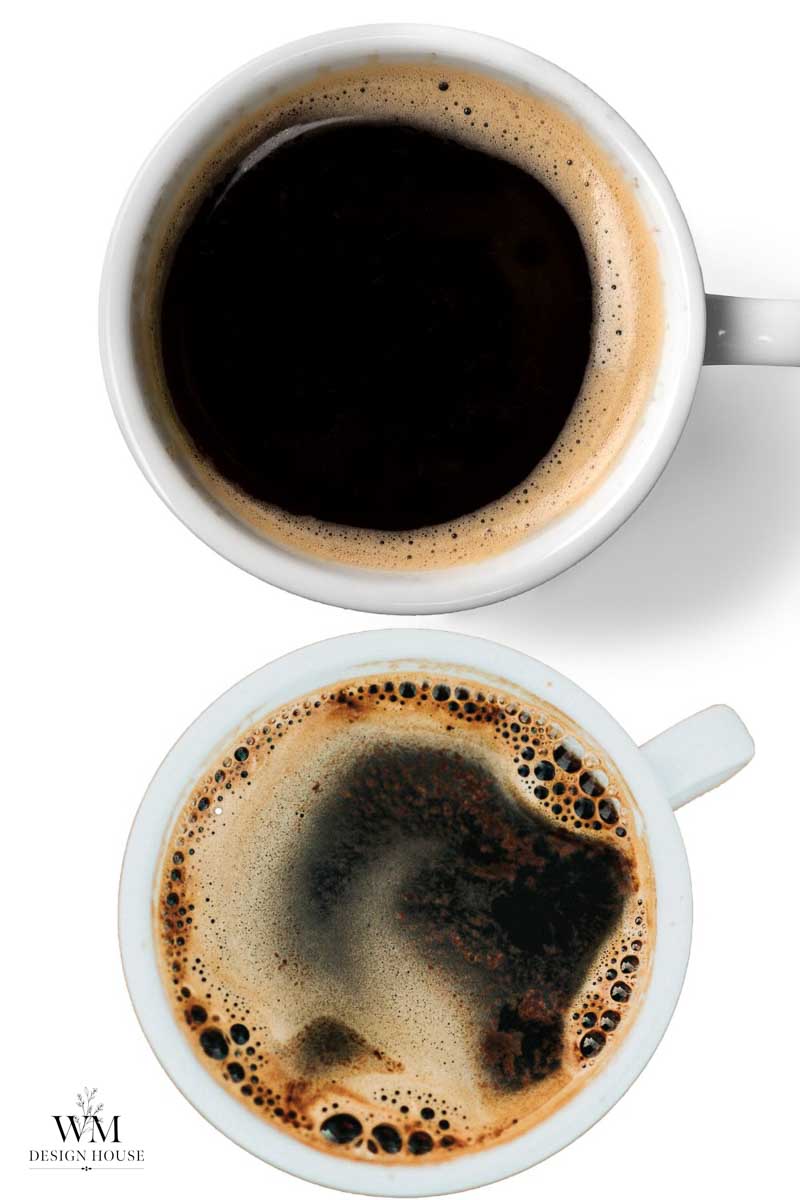 Two white mugs filled with black coffee, viewed from above on a white background. The coffee has bubbles and froth on the surface, reminiscent of the textures you might observe when learning how to make coffee paper. A small WM Design House logo is in the lower left corner.