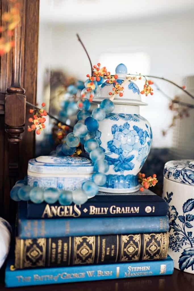Blue books used as a riser under blue and white china for display.