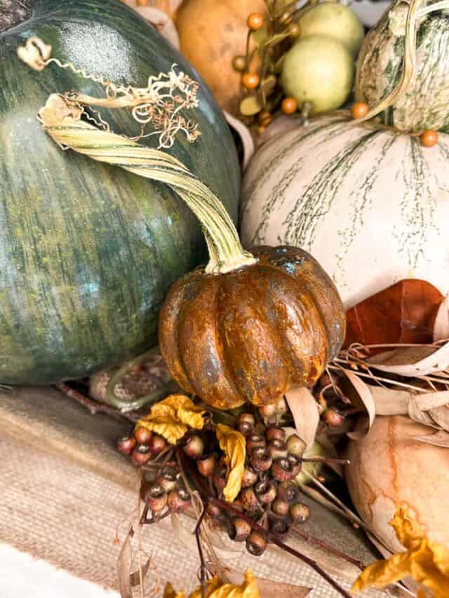 Pumpkins in a wooden dough bowl for a centerpiece on the kitchen table.