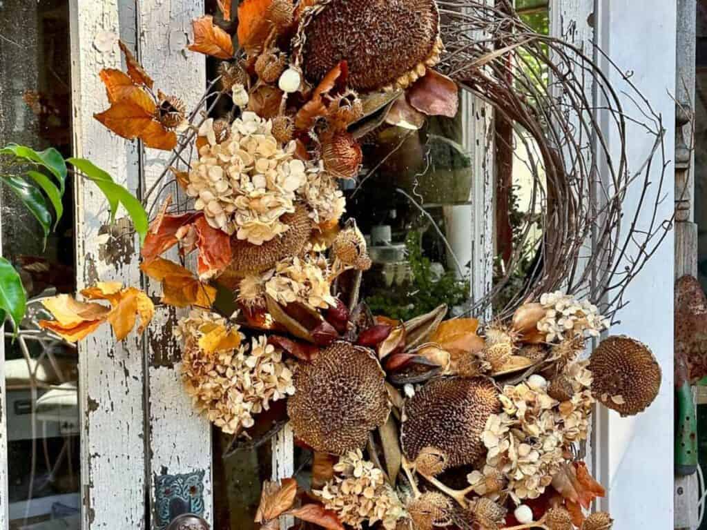 Foraged fall wreath hanging on the door