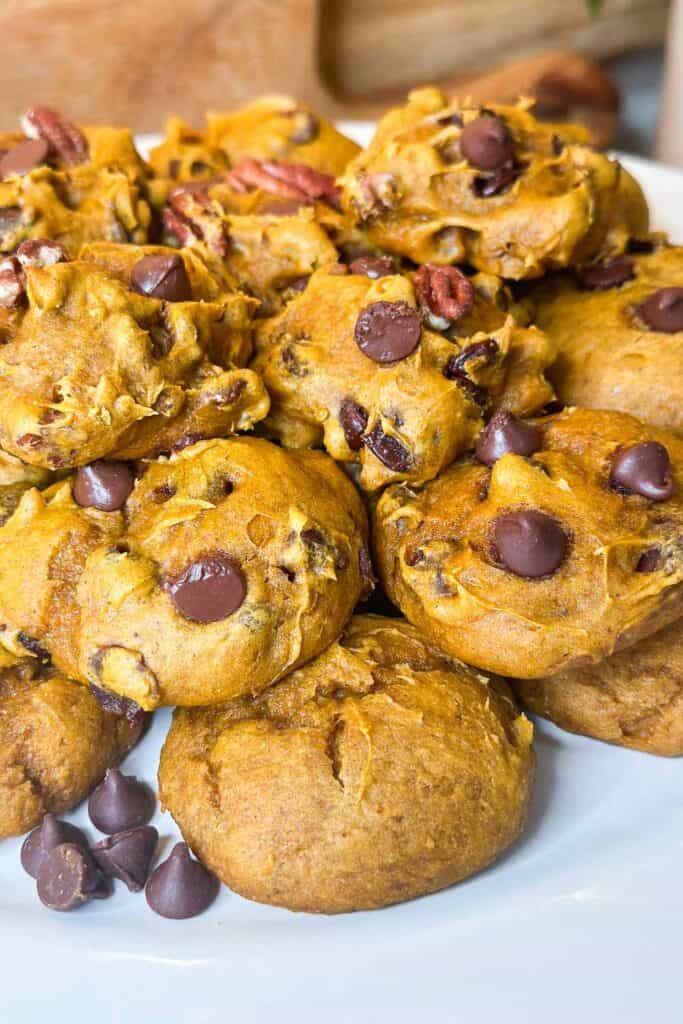 3 ingredient pumpkin cookies with chocolate chips and pecans on a plate 