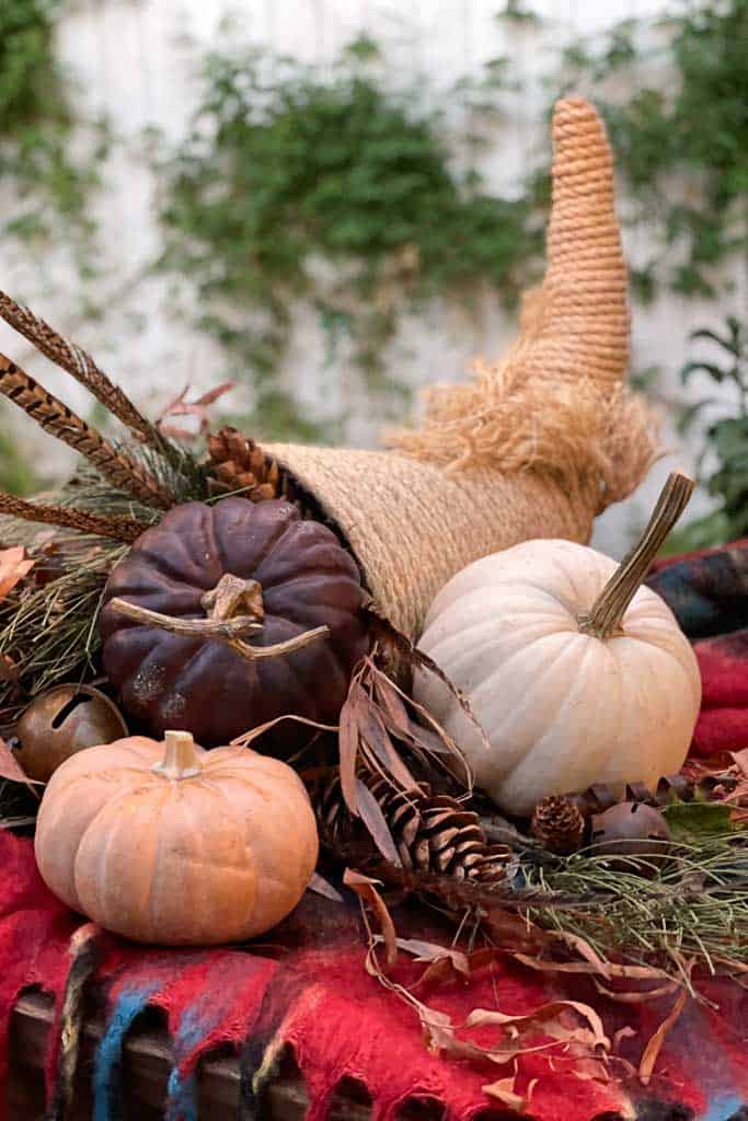 DIY Rope cornucopia filled with pumpkins as a Thanksgiving Centerpiece. 