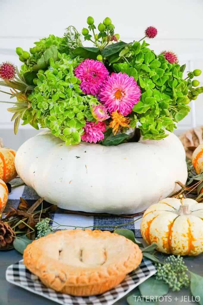 White pumpkin filled with fresh flowers. 