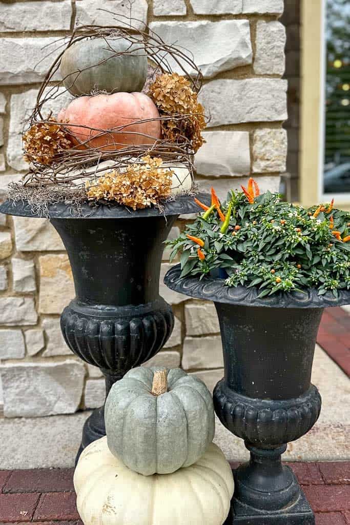 Urns filled with a topiary of pumpkins. 