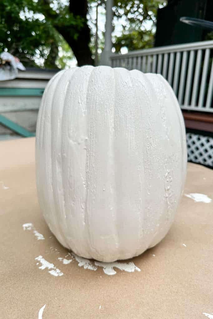 White pumpkin that has been painted with chalk paint and baking soda. 