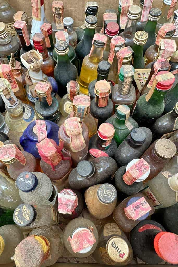 A box full of very old mini liquor bottles 