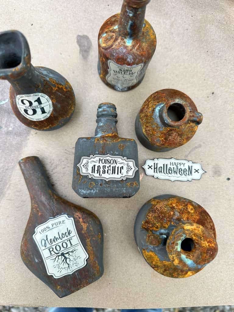 Rusty patina bottles with apothecary labels being put on. 