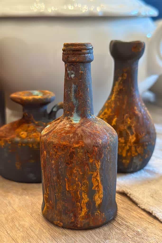Rusty mini liquor bottles are created with a unique painting process. 