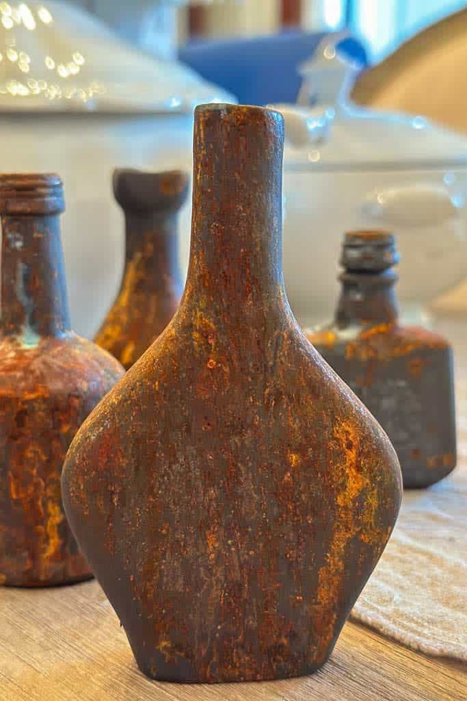 It's an old mini liquor bottle with a rusty patina finish. 