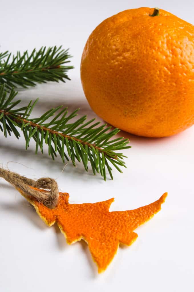 A small Christmas tree cut out of an orange ring and turned into a Christmas tree ornament. 