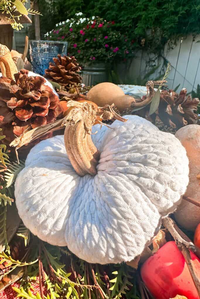 White stuffed fabric pumpkin as a decoration on the Thanksgiving table.