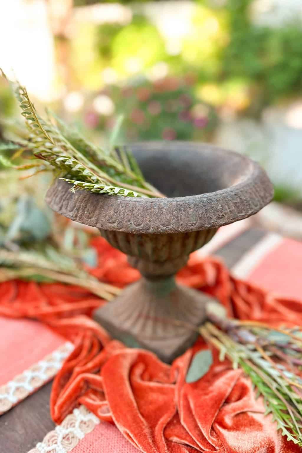 Blue and Orange Thanksgiving Table Decor Ideas-A vintage urn sits on a table, ready to create a centerpiece for a Blue and orange tablescape for Thanksgiving.