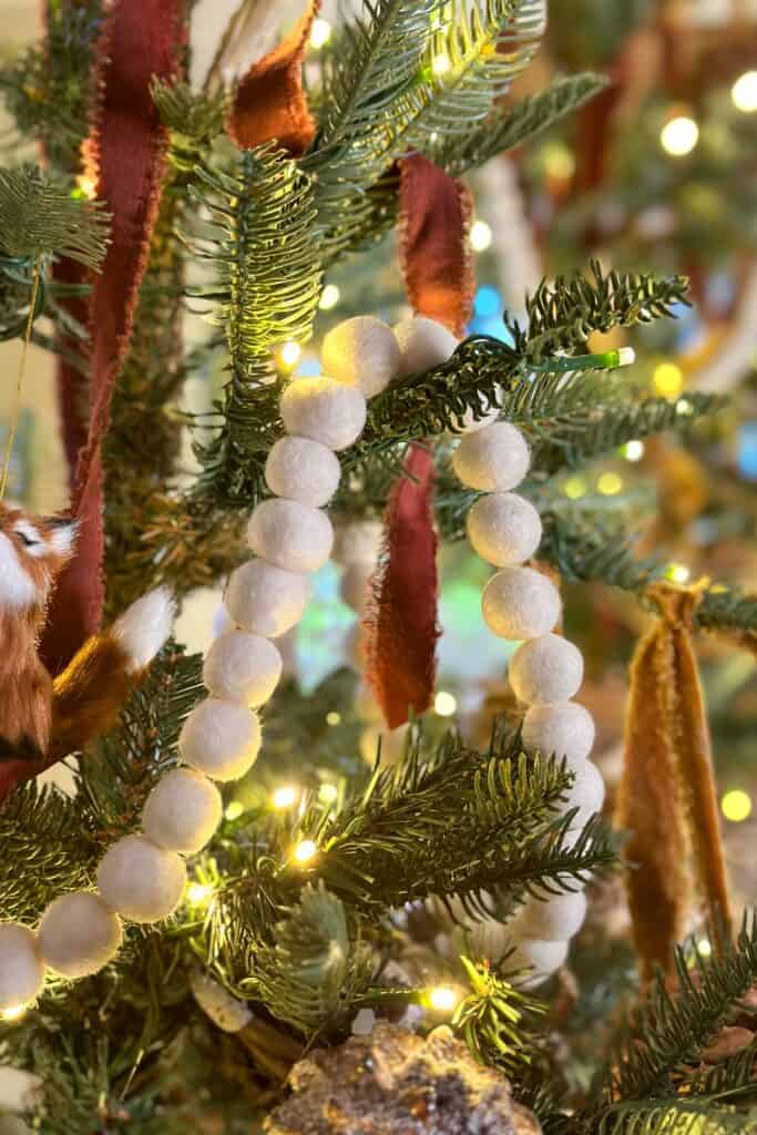 Pom pom garland on a green and gold tree for Christmas