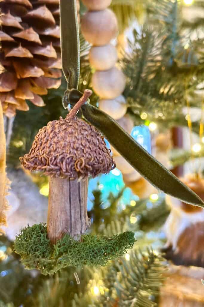 A mushroom ornament made out of a small birch branch and an acorn cap.