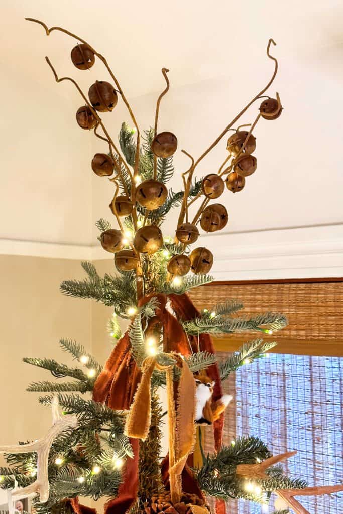 Rusty bells on top of the Christmas tree with velvet ribbon 