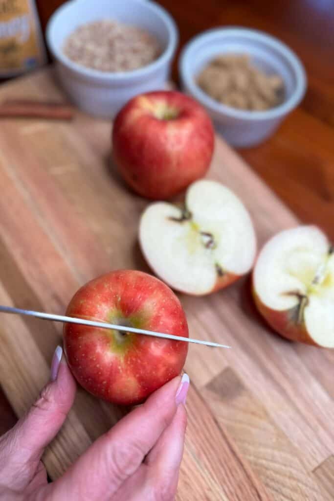 Cutting apples in half to make baked air fryer apples