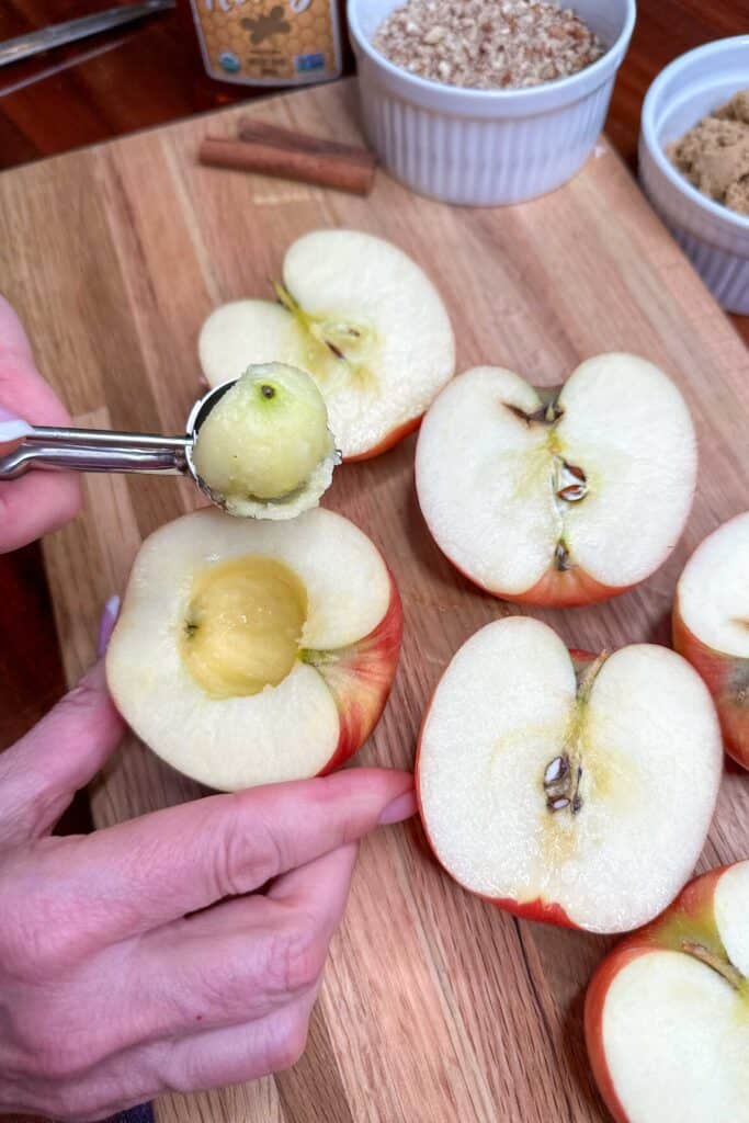 Removing the core from apple halves.