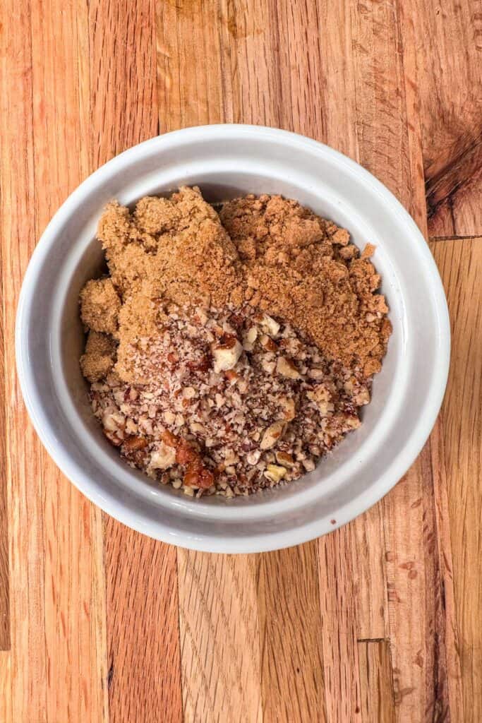 Brown sugar, pecans, and gingersnaps are crushed to make a crumble topping for baked apples.