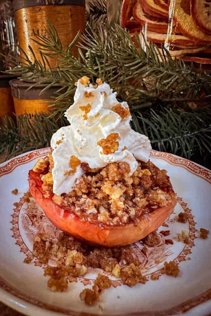 Baked Apple with whipped cream and pecan gingersnap crumble.