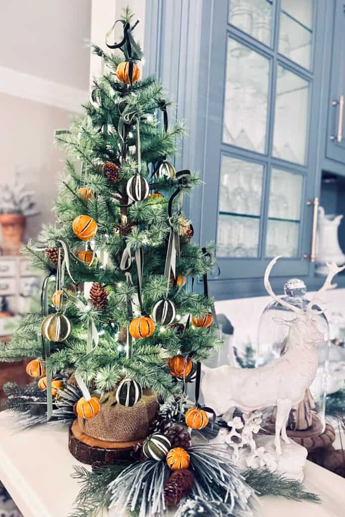 Whole dried oranges hanging on a small Christmas tree for decoration. 