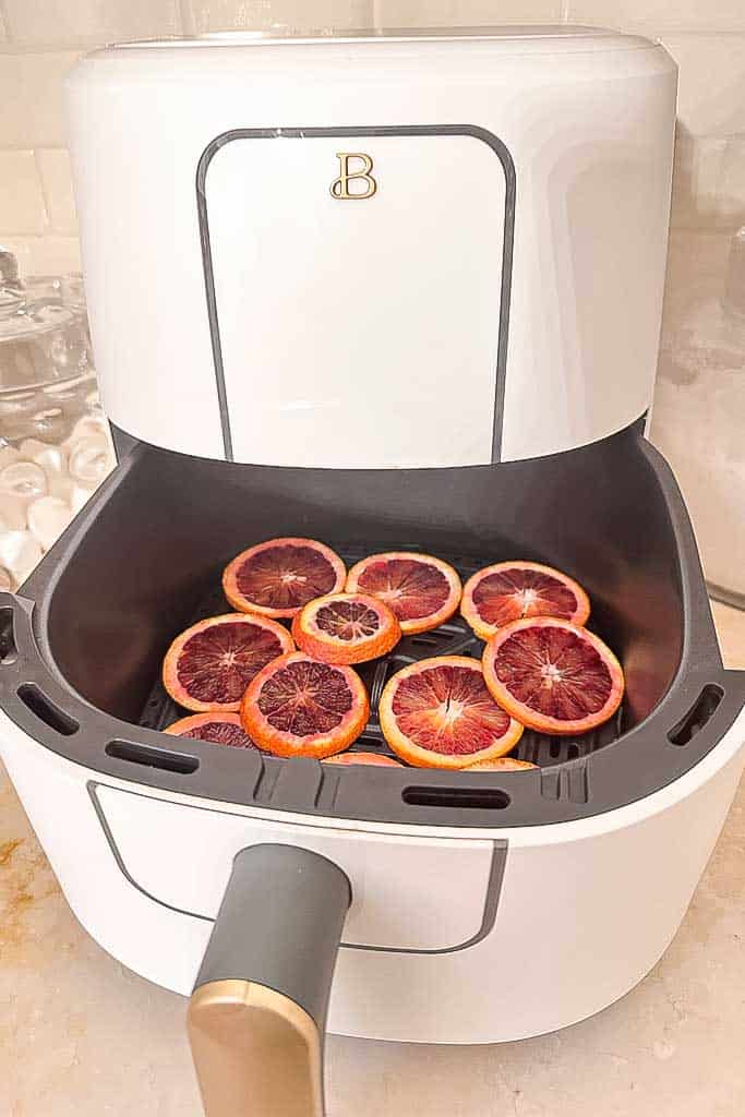 Oranges slices in the Air Fryer, getting ready to dehydrate them.