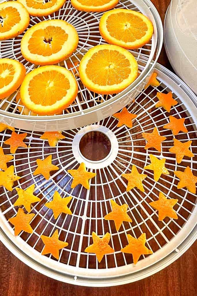 Cut out stars from orange rind and get ready to dry them in a dehydrator.