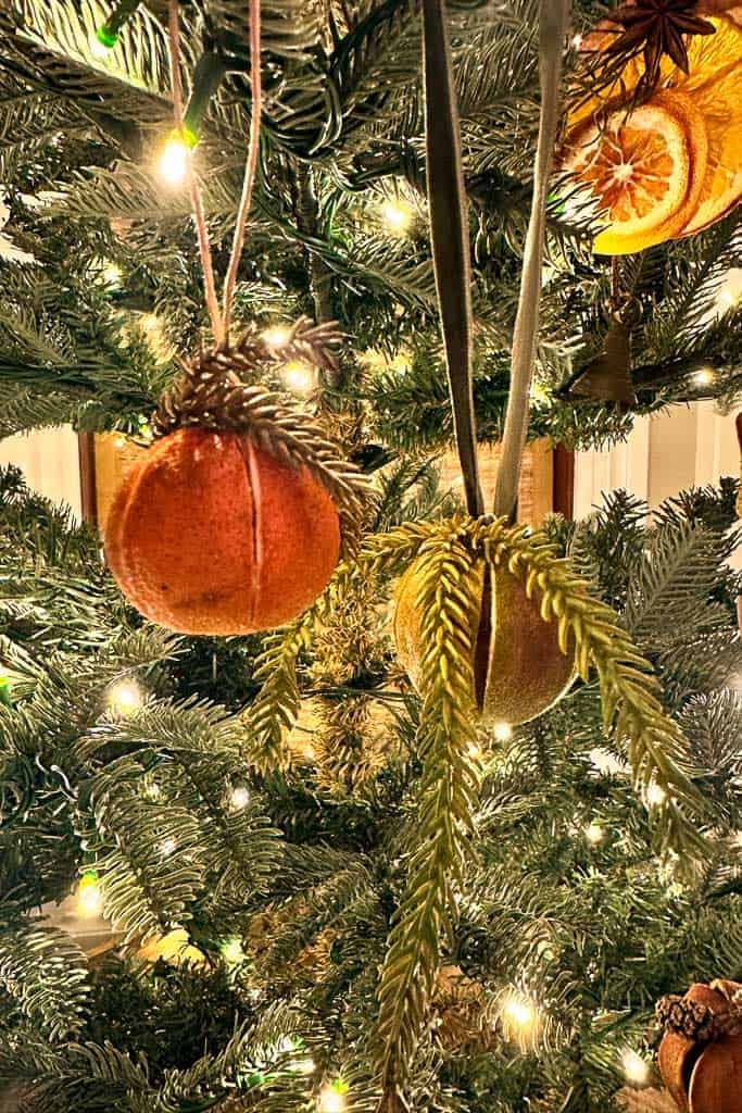 Whole dried oranges decorated and hanging in the Christmas Tree