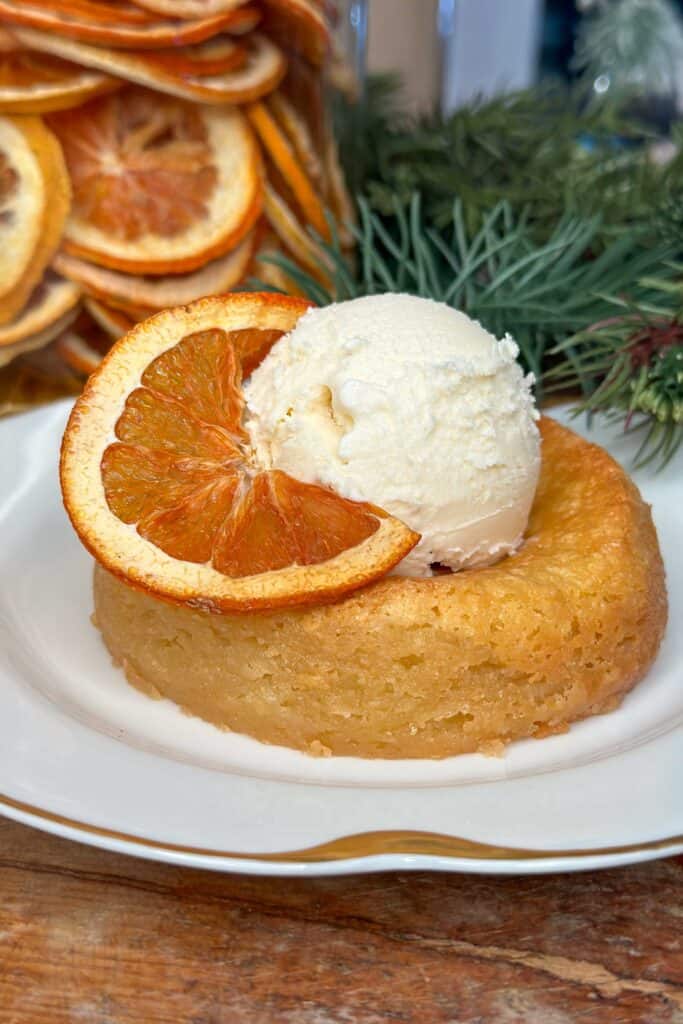 Mastro's copycat butter cake with a scoop of vanilla ice cream and a slice of dried orange for garnish.