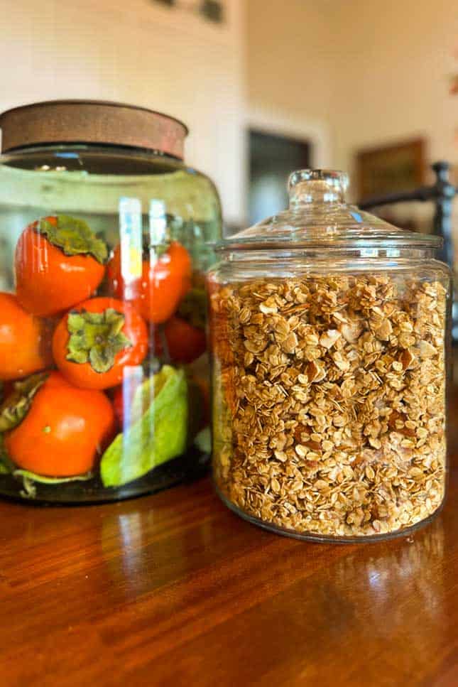 A jar filled with granola sits on the kitchen counter for easy snacking. 