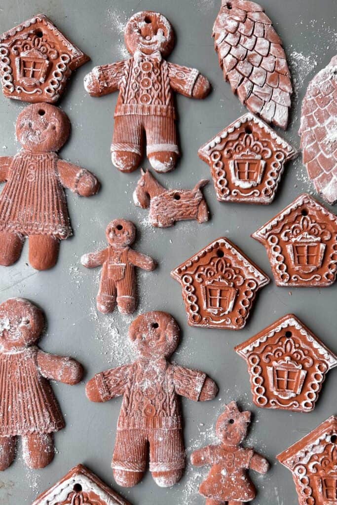 Air dry clay ornaments on a cookie sheet to dry. Gingerbread men and gingerbread houses.
