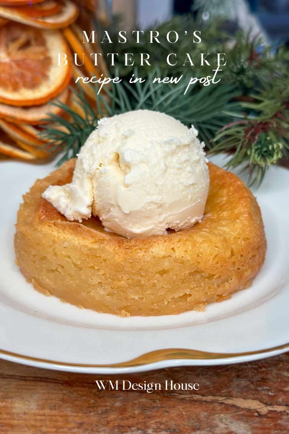 Individual butter cake with ice cream and a slice of dried orange.