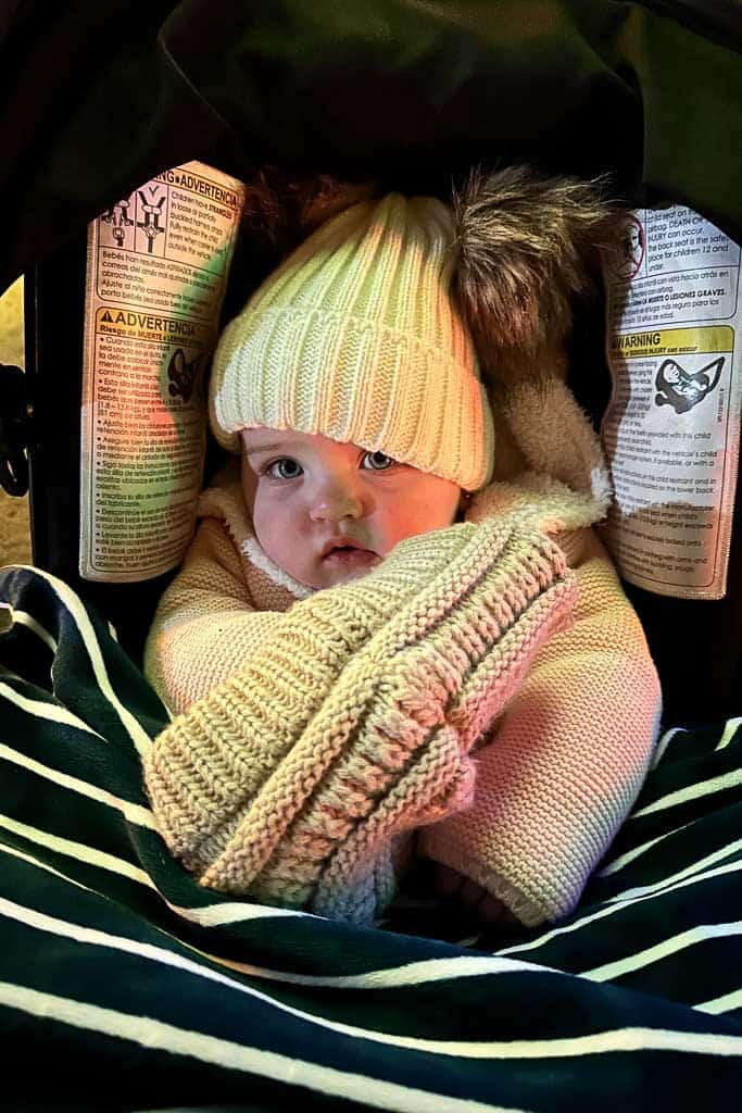 baby bundled up in a hat and sweater