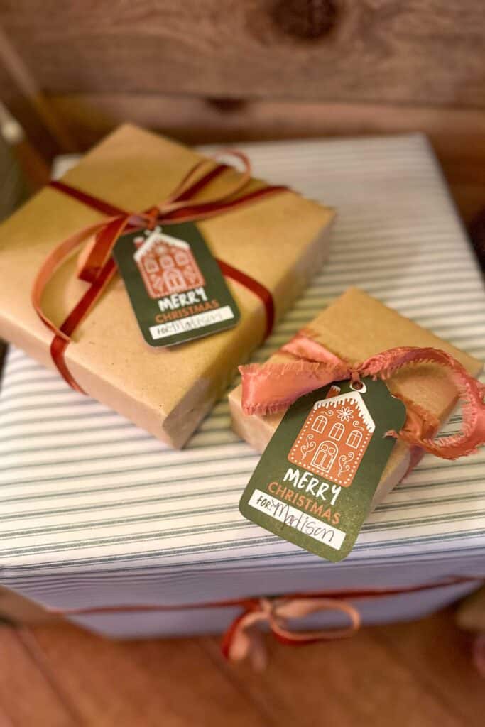 Free printable gingerbread house gift tags wrapped on top of a package.