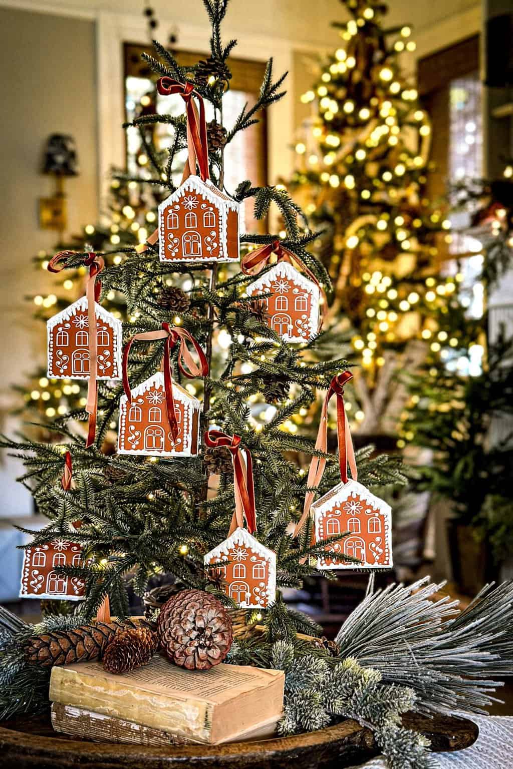 3D printable gingerbread houses that are folded and glued, hanging on a small Christmas tree. 