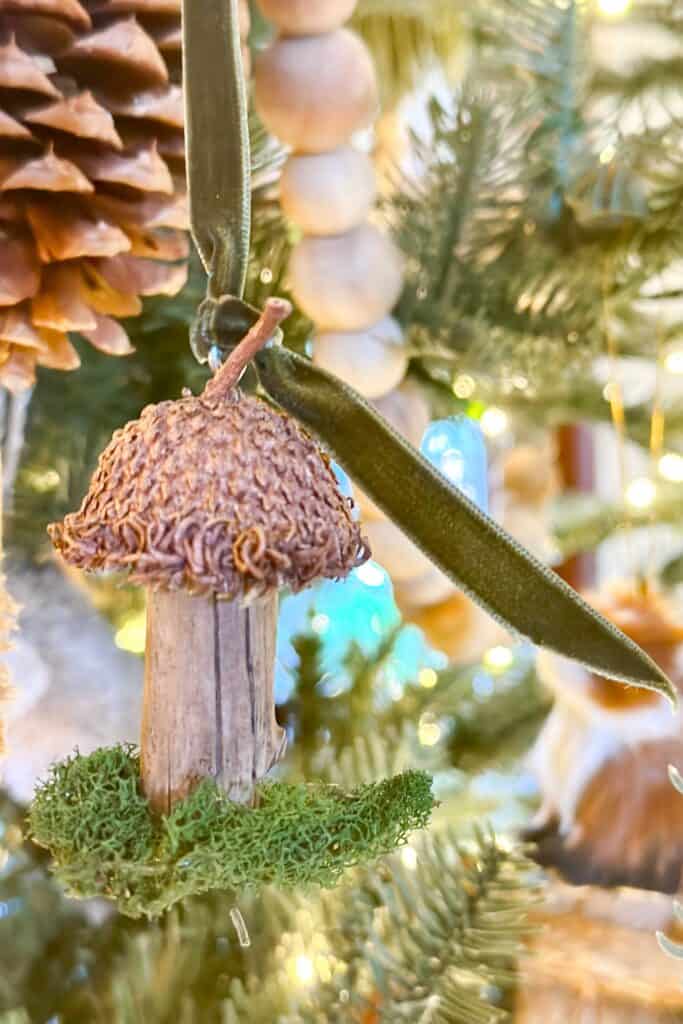 DIY natural mushroom hanging in the tree with a bit of moss and velvet ribbon.