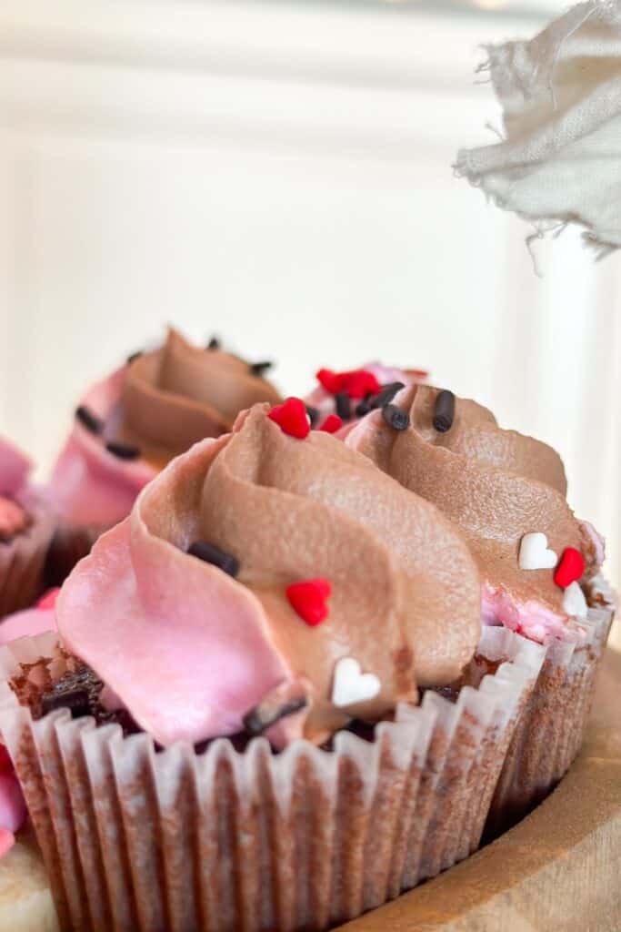 Chocolate cupcakes decorate a tiered treat tray for Valentine's Day.