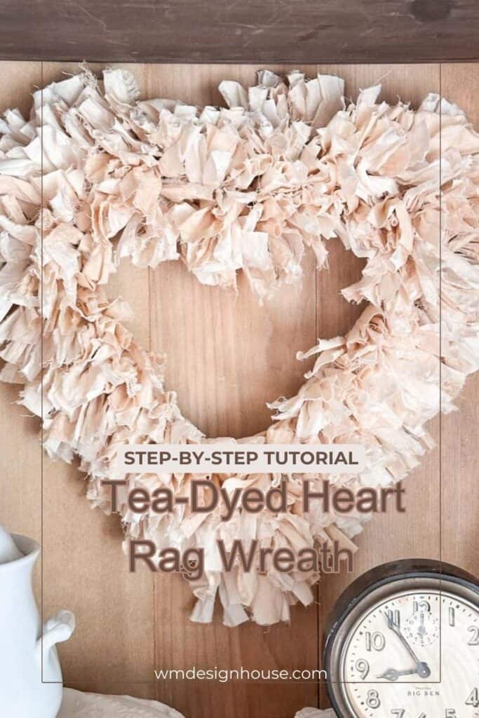 DIY rag wreath in the shape of a heart where the fabric is tea-dyed. It is hanging on the shed door. 