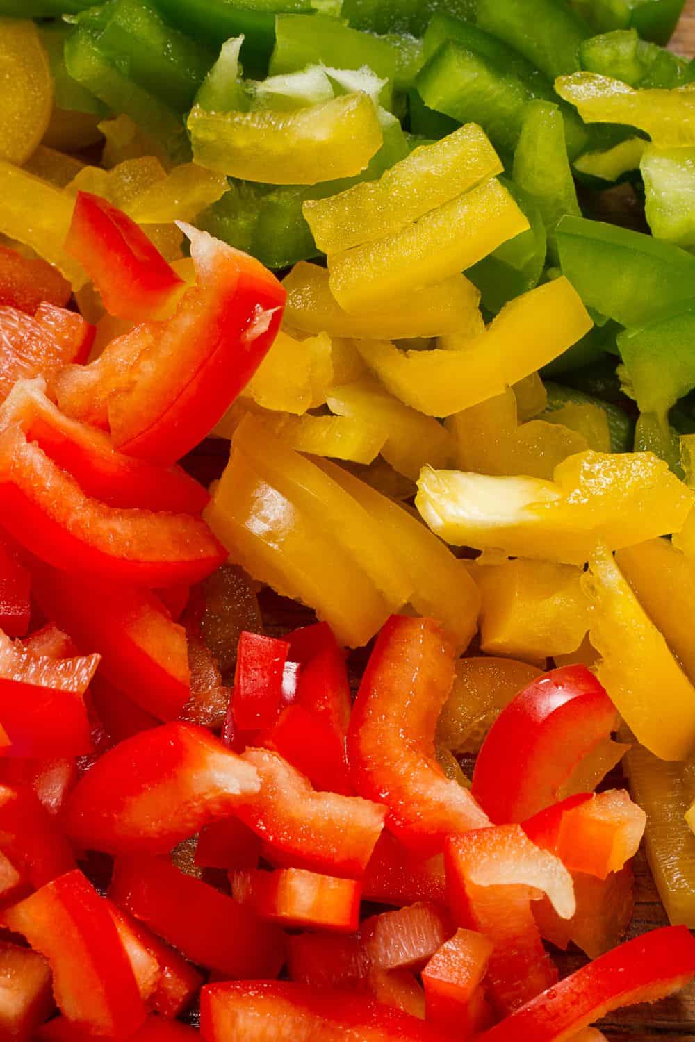 Red, green, and yellow bell peppers - 35 of the best nacho toppings. 
