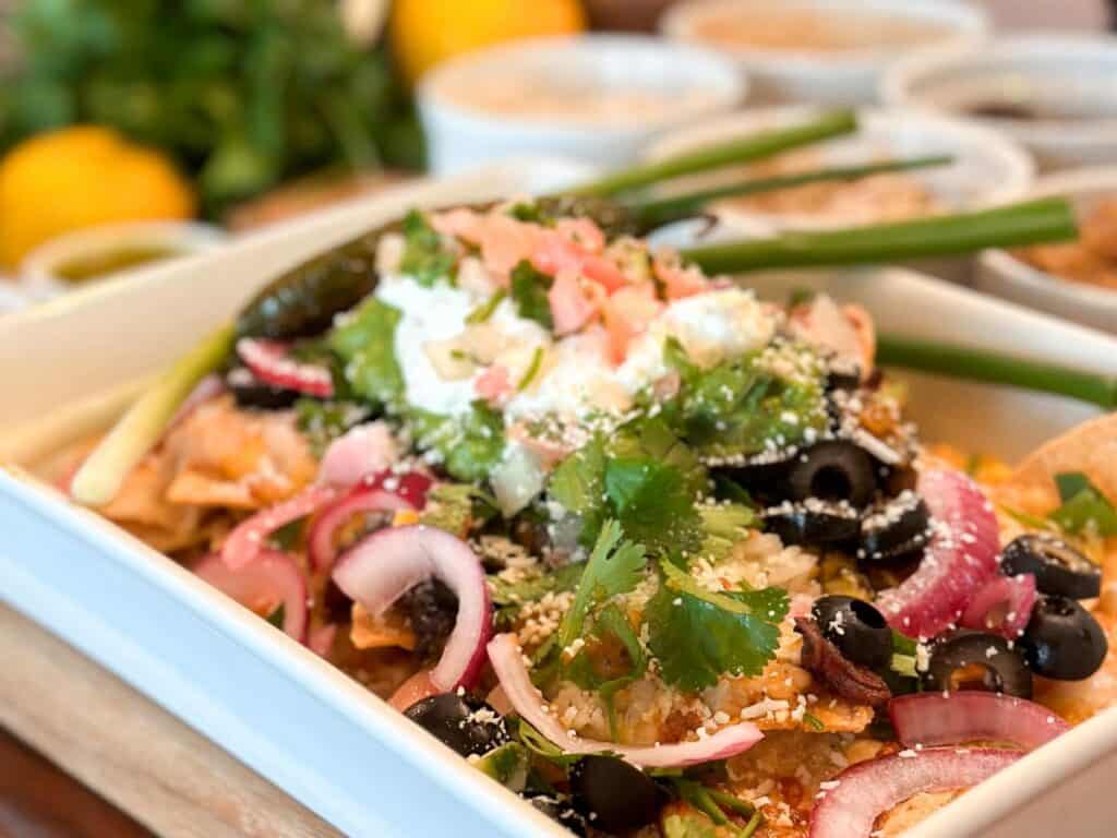 The perfect plate of nachos, with over 35 toppings to choose from. Corn chips are covered with meat, chips, salsa, sour cream, and more.