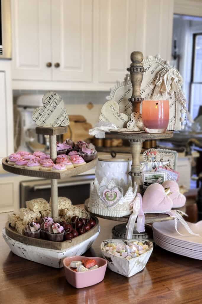 A display of Valentine's sweets and decor on a tiered tray in the kitchen.