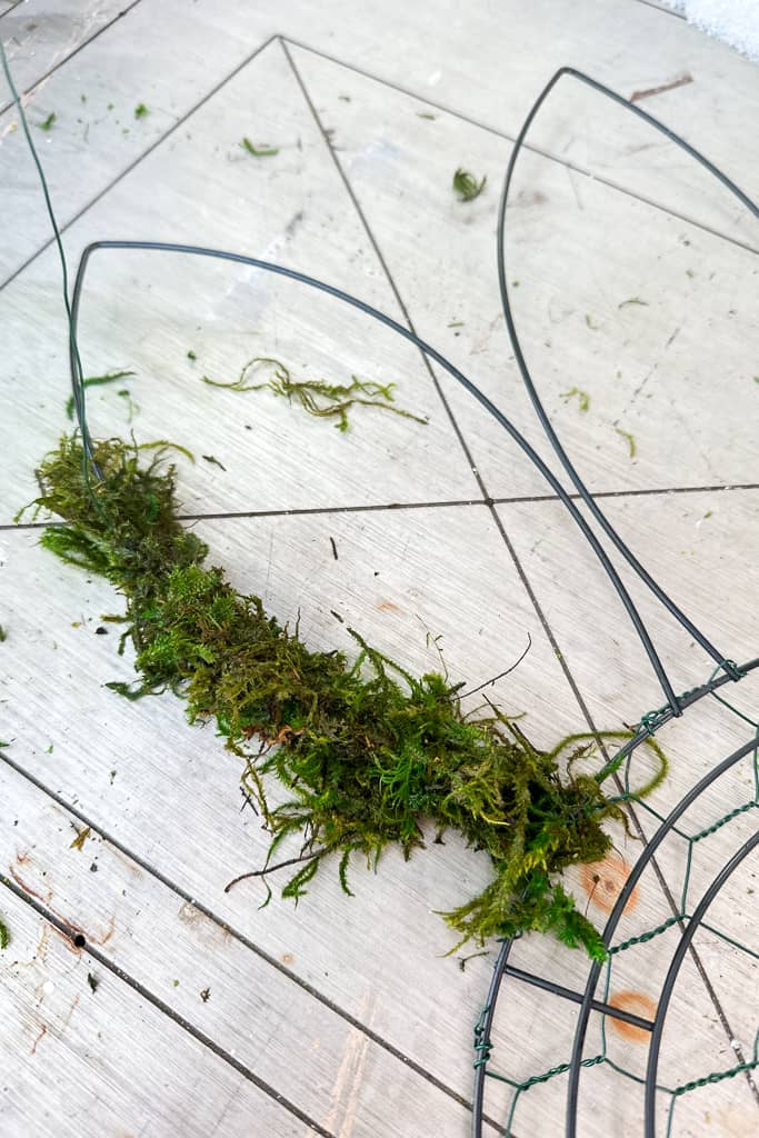 Adding moss to a bunny's ear on a Dollar Tree wireframe.